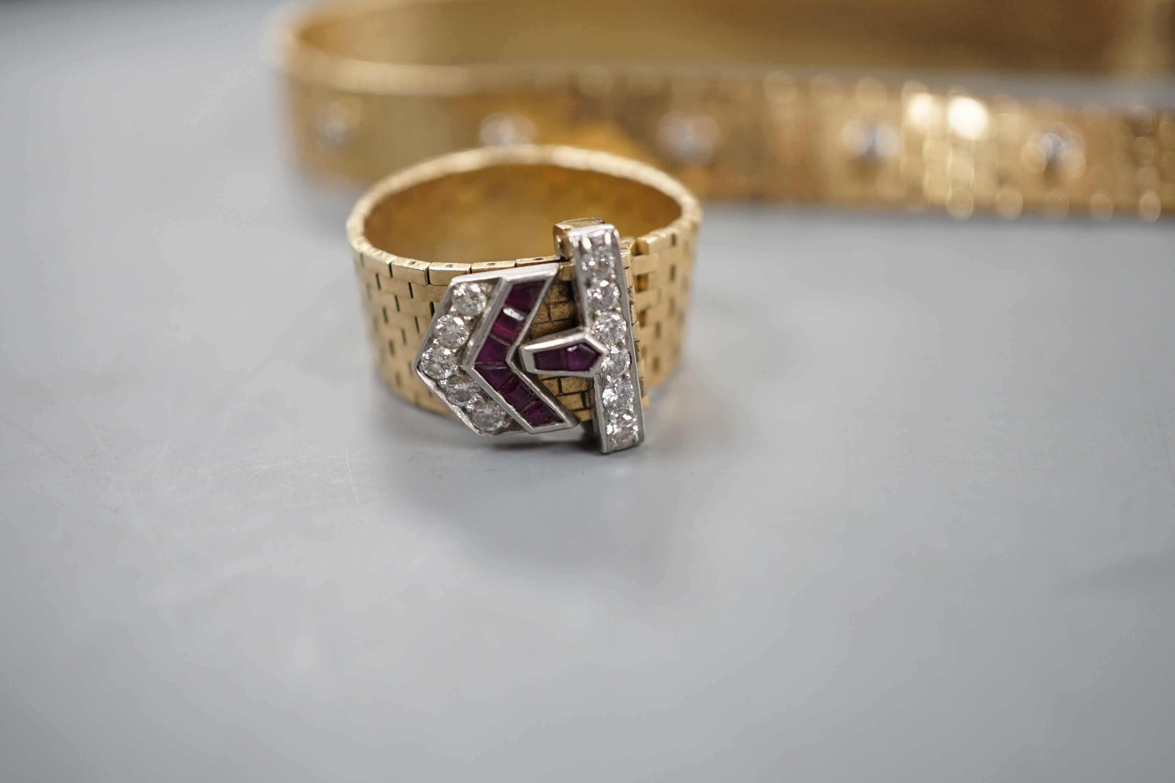 An unmarked yellow metal, ruby and diamond necklace, with 'buckle' clasp, 67cm and a matching ring, size U/V, gross weight 58.3 grams.